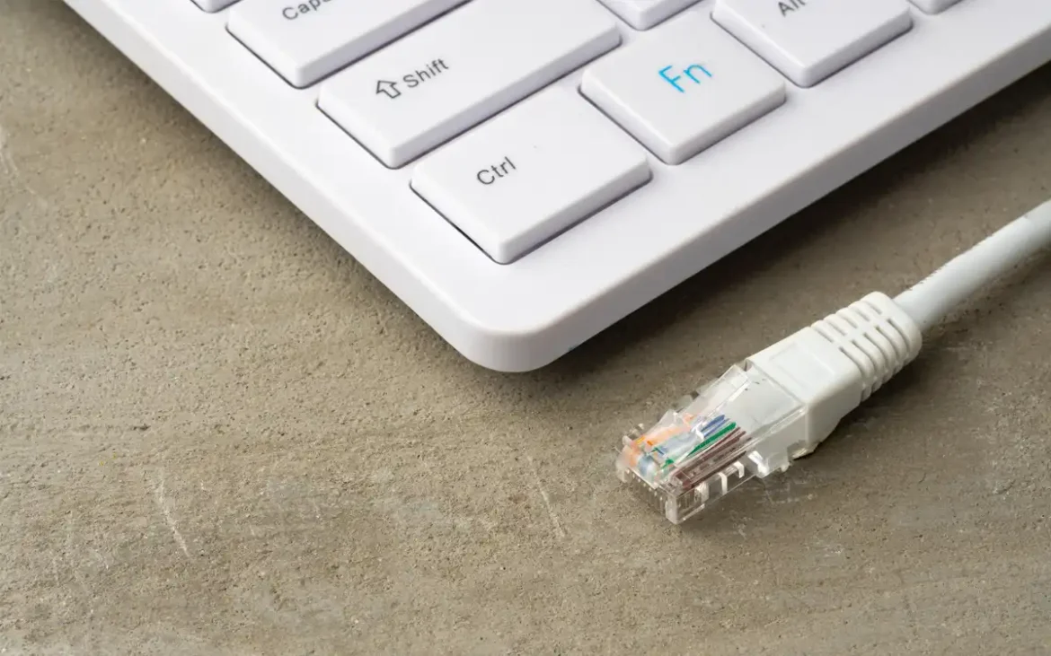 Cable Ethernet junto a un teclado de computadora